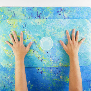 Kati Kaia artrist yoga mat with pad in blue and green abstract design with hands on mat