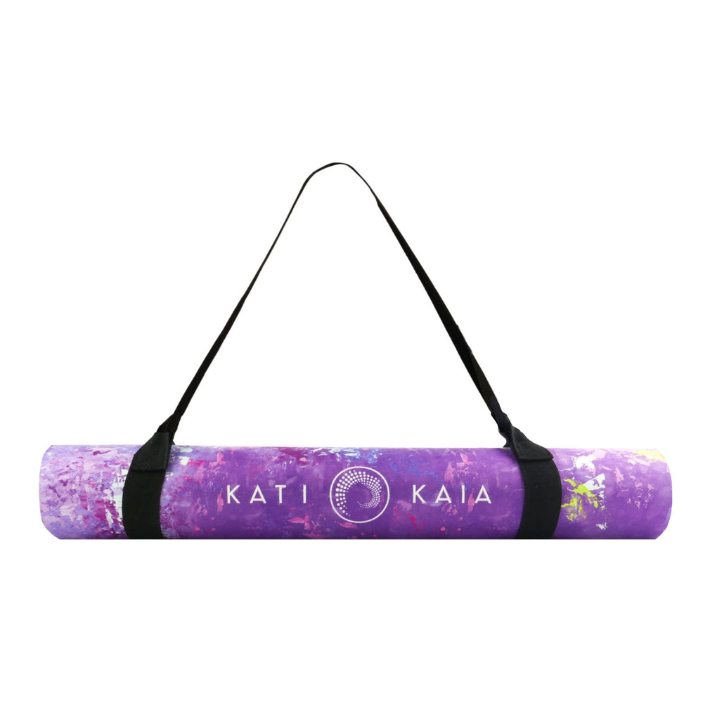 Kati Kaia purple artistic yoga mat rolled up with black carrying strap and floral pattern