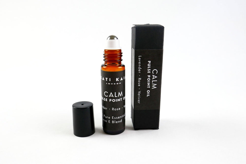 Kati Kaia calm pulse point oil with lavender, rose, and vetiver in amber glass roller bottle and black box