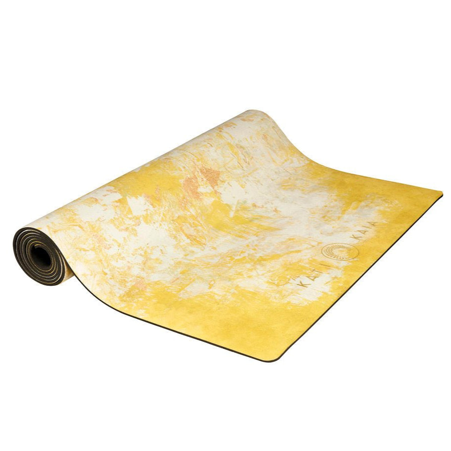 Kati Kaia yellow artist yoga mat partially rolled with a textured artistic yellow and white design