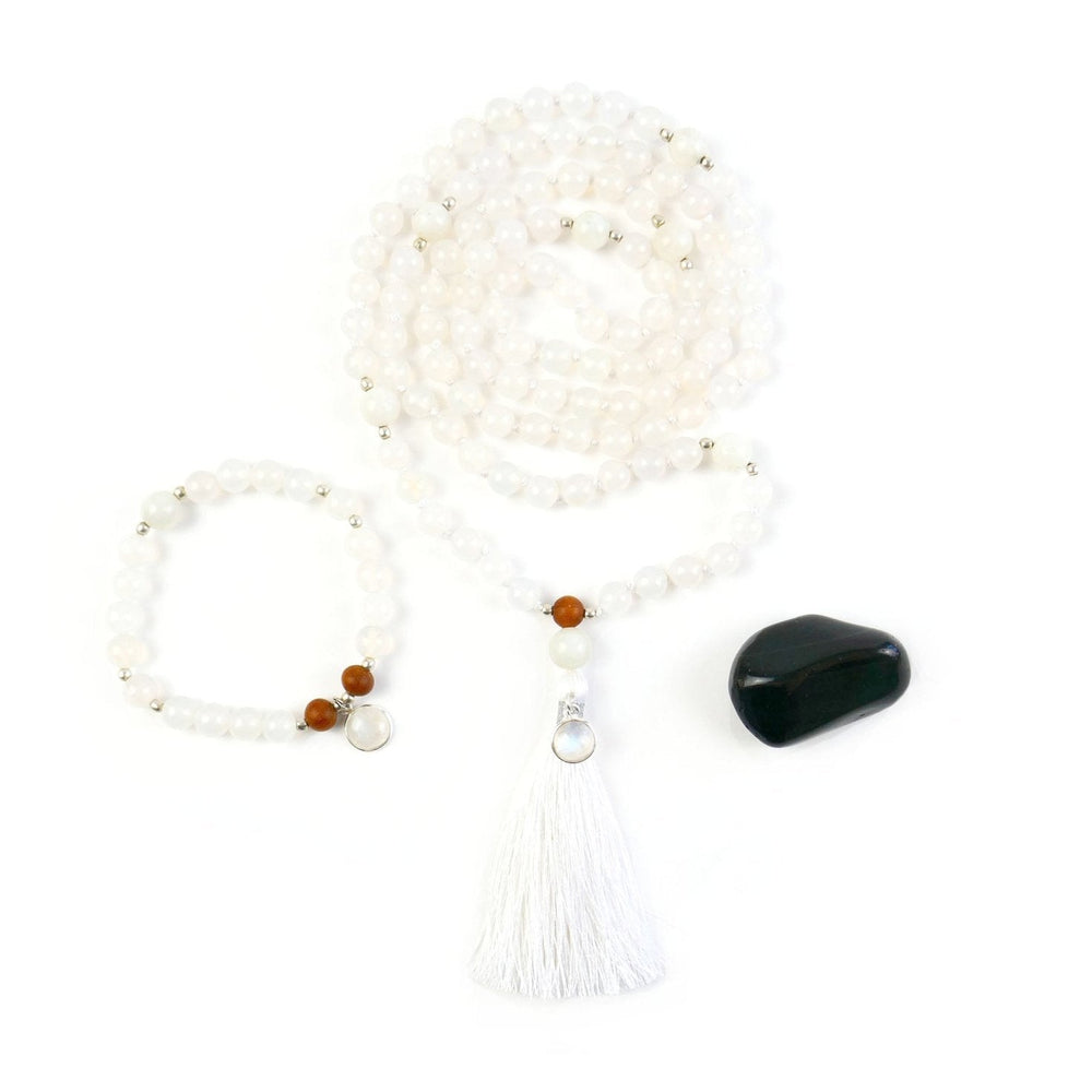 Kati Kaia white moonstone mala necklace set with tassel and matching bracelet displayed with black stone