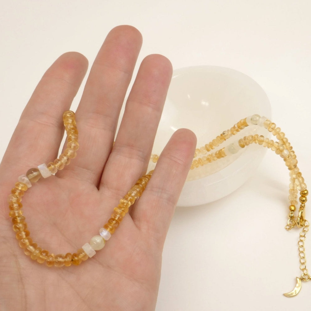 Kati Kaia pure citrine gemstone jewellery necklace held in hand with translucent round beads